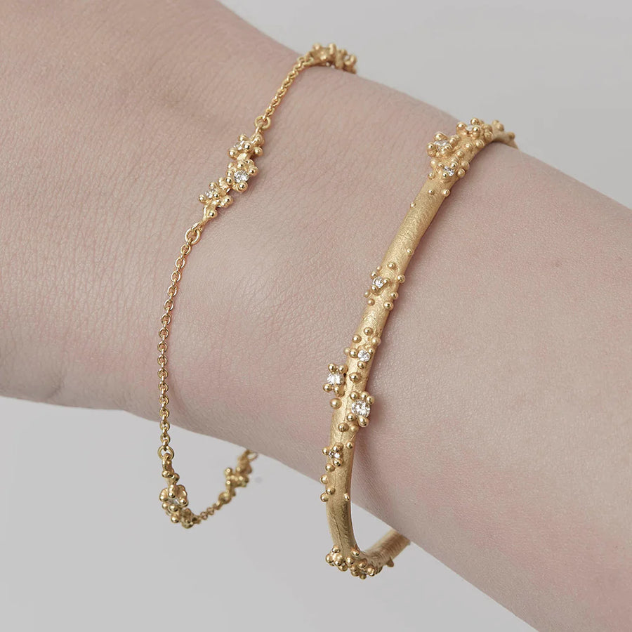 Gold bracelets on wrist