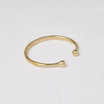 Simple round brass cuff with rounded balls at the opening - Marisa Mason Jewelry