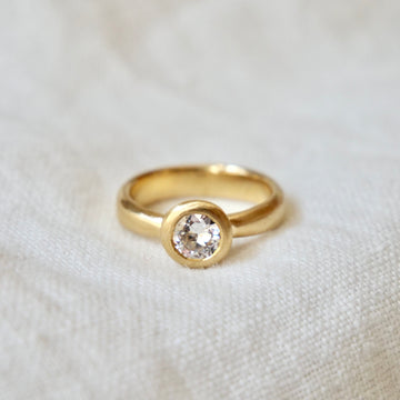 Classic Bezel Ring with a large white diamond and tapered band