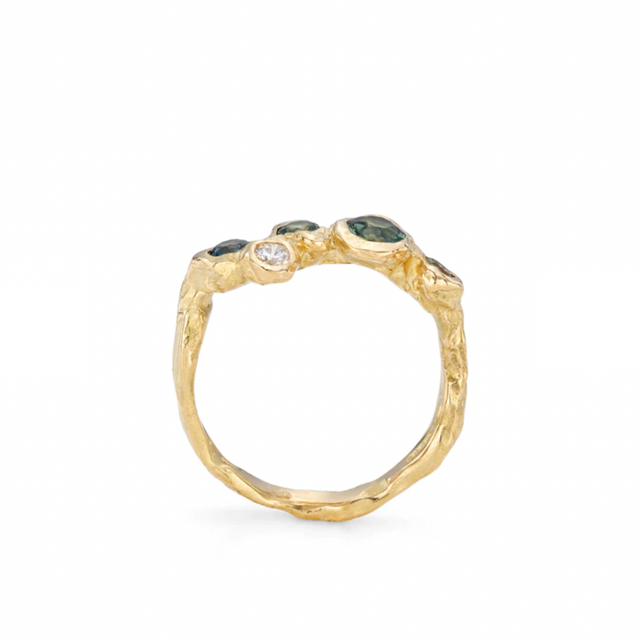 This ring has a distinctly lower height for those that prefer a neat, flatter profile. D<span>efined by irregular 'pebble' settings, the stones in the ring are arranged to be delightfully askew; distinctive in their tilting, organic formation.</span>