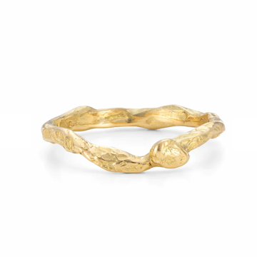 An irregular, rocky wedding band created to sit with a solitaire ring 