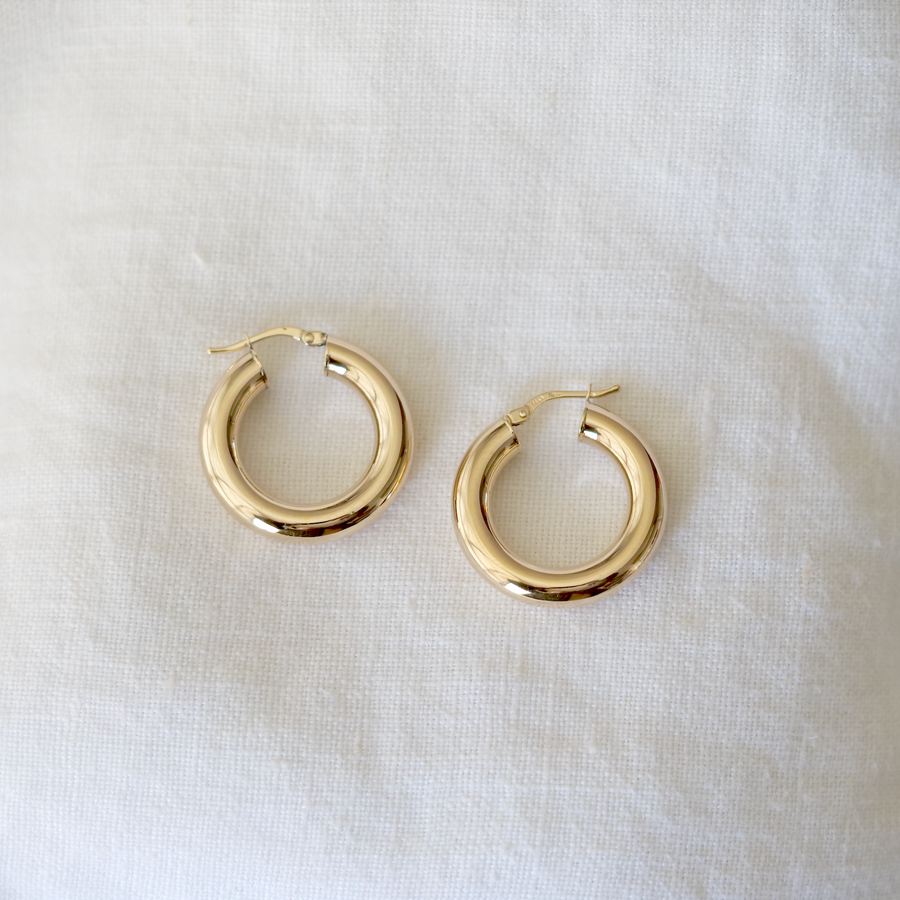 5mm thick, hollow hoops in 14k solid gold with hinge clasp, on white linen background
