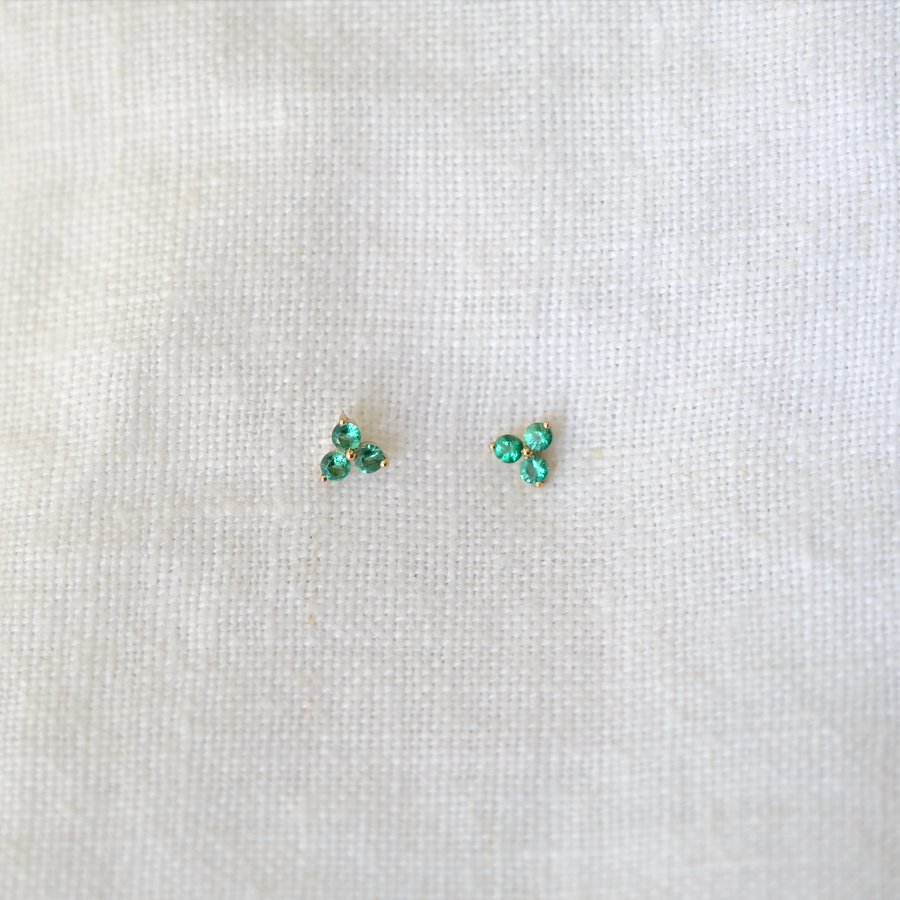 3 emeralds prong set in 14k gold on a gold post