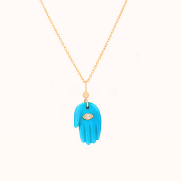 Carved turquoise hand pendant with inlayed marquise diamond at the center, with a gold jump ring with white diamond