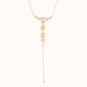 GOLD LARIAT NECKLACE WITH MOONSTONE AND DIAMONDS WITH DANGLING DETAILS. 