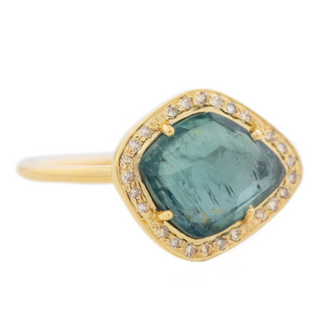 One of a kind gorgeous soft blue irregular tourmaline, surrounded by white diamonds, set in 14k yellow gold.