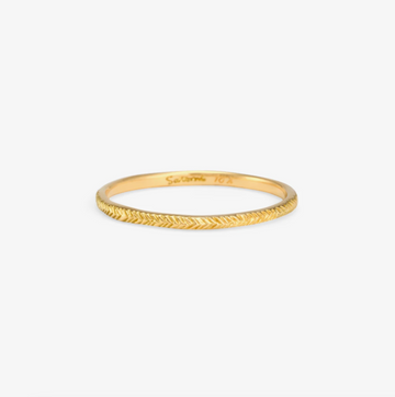 18k gold band with herringbone style etching in the surface. 