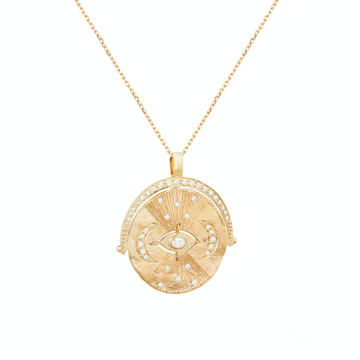 14k gold medallion with central eye and two moons, all set with white diamonds. 18 inch 14k chain