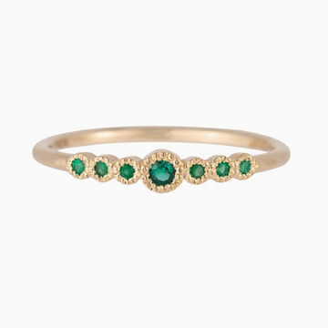 Jennie Kwon Designs round emeralds set in 14k gold seven emeralds engagement ring