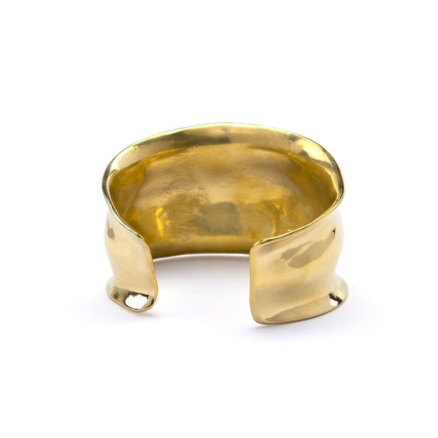 Wide cuff with high shine finish, with a curved texture and ridged edges, made of brass
