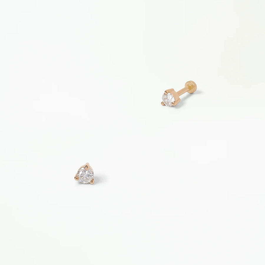 small gold and diamond studs earrings on a white background