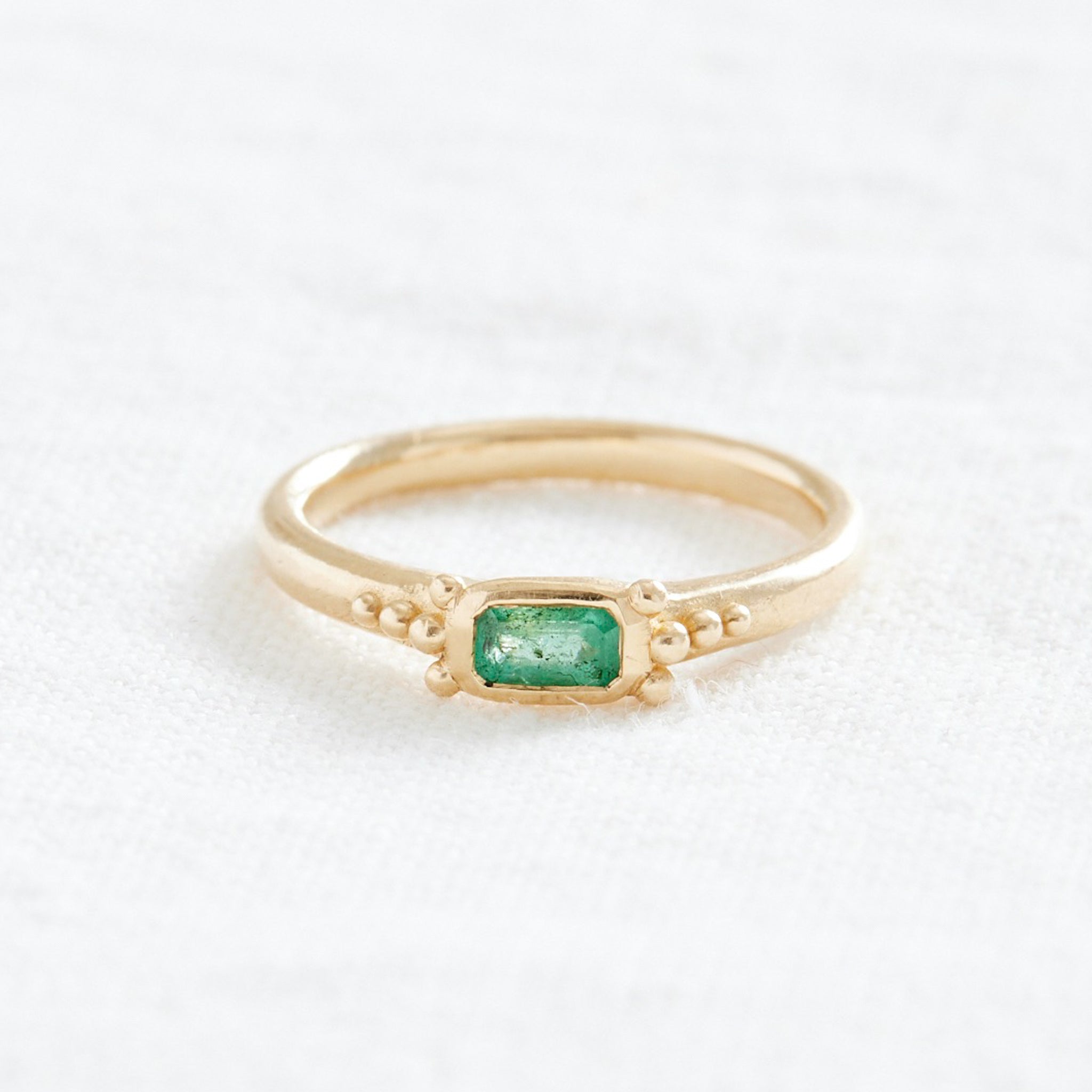 Gold ring with green stone and gold granulation details 