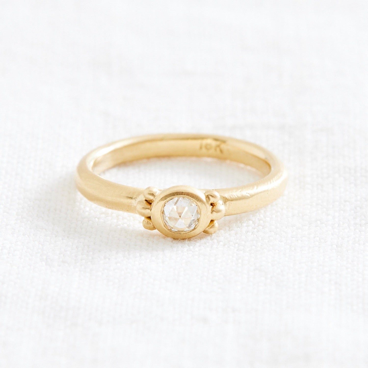 gold ring with diamond and gold detail 