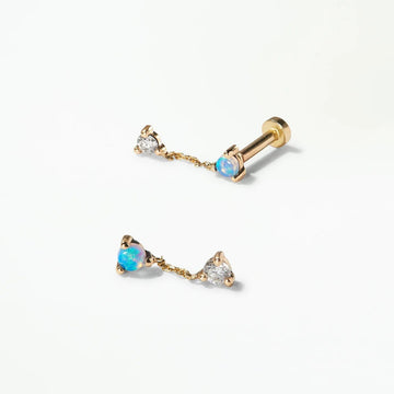 Gold earrings with gemstones on a white background