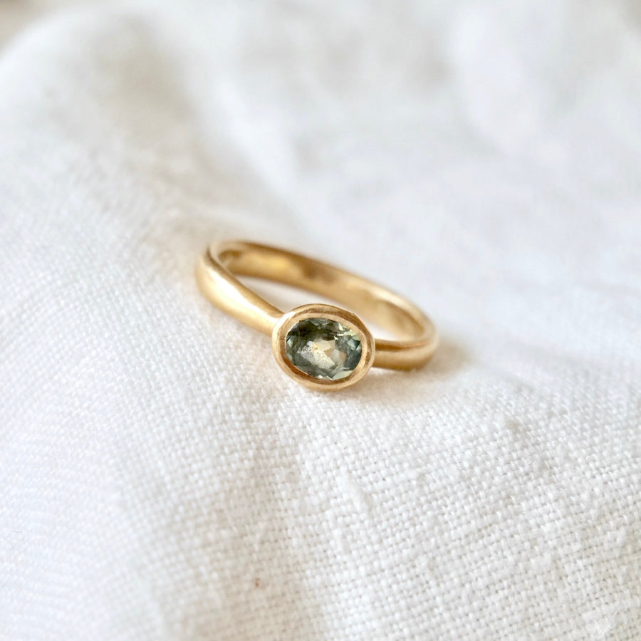 Simple and beautiful, ocean colored light blue/green tourmaline set in 18k yellow gold.