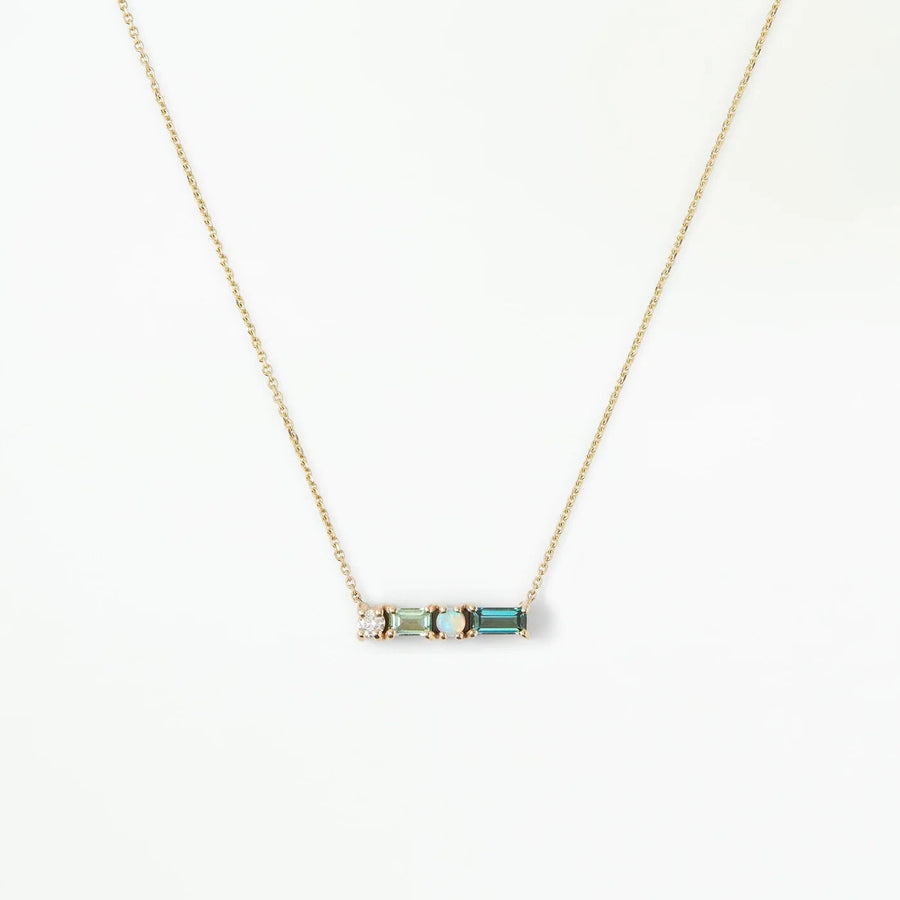 Necklace with a small gold pendant set with a diamond, light green tourmaline baguette, opal and dear teal tourmaline baguette, on a white background