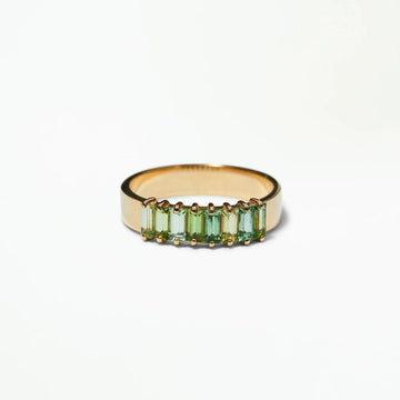 Tourmaline baguettes in parallel formation on a thick gold band