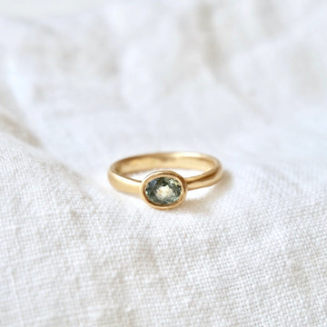 Simple and beautiful, ocean colored light blue/green tourmaline set in 18k yellow gold.