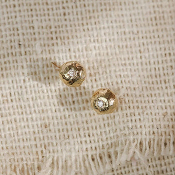 Lightly textured, organic pebble shaped studs with glistening diamonds