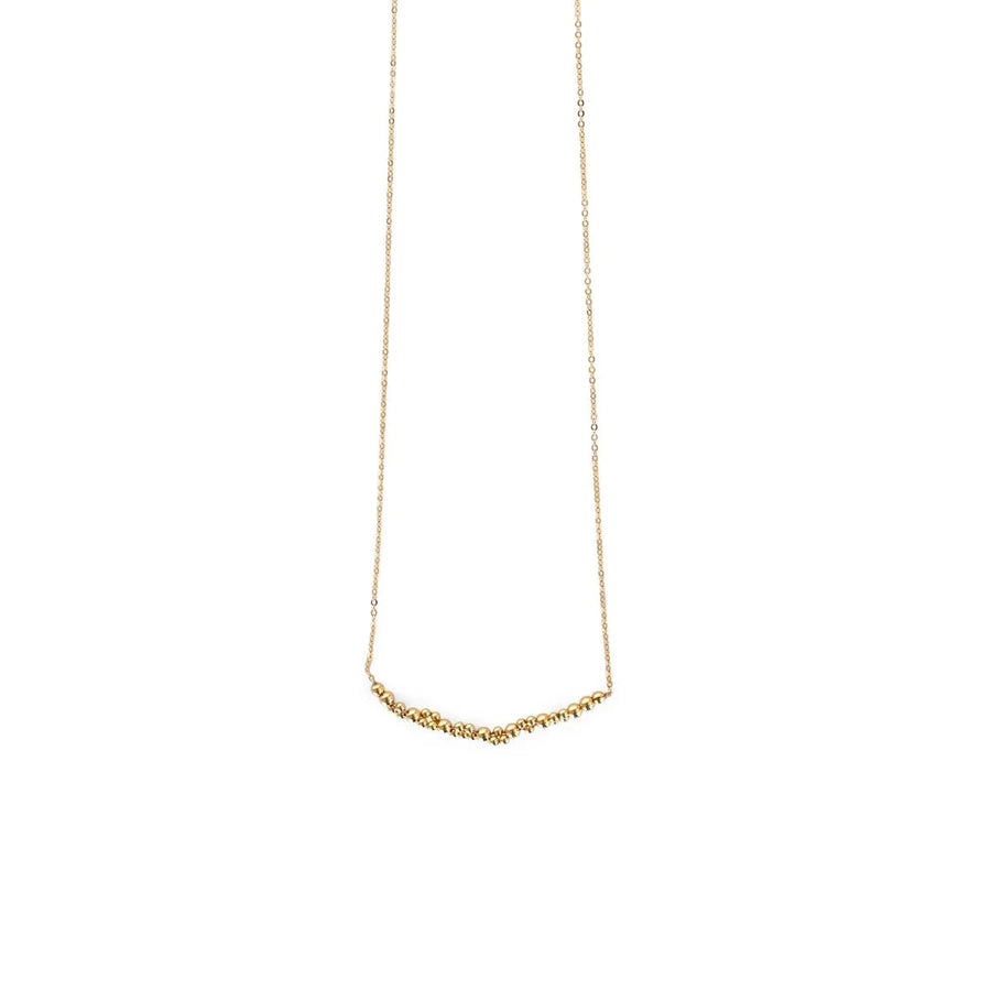 small gold beads in an arch cluster, hanging on a delicate chain