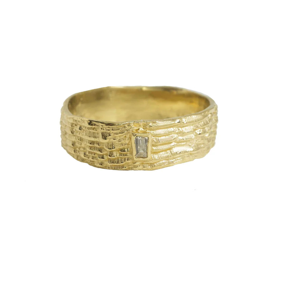 Fractured Band comes in 14k Yellow Gold and a recycled baguette diamond, and is Inspired by the corrosion of rock patterns staking up on top of each-other after millions of years and tectonic shift. 