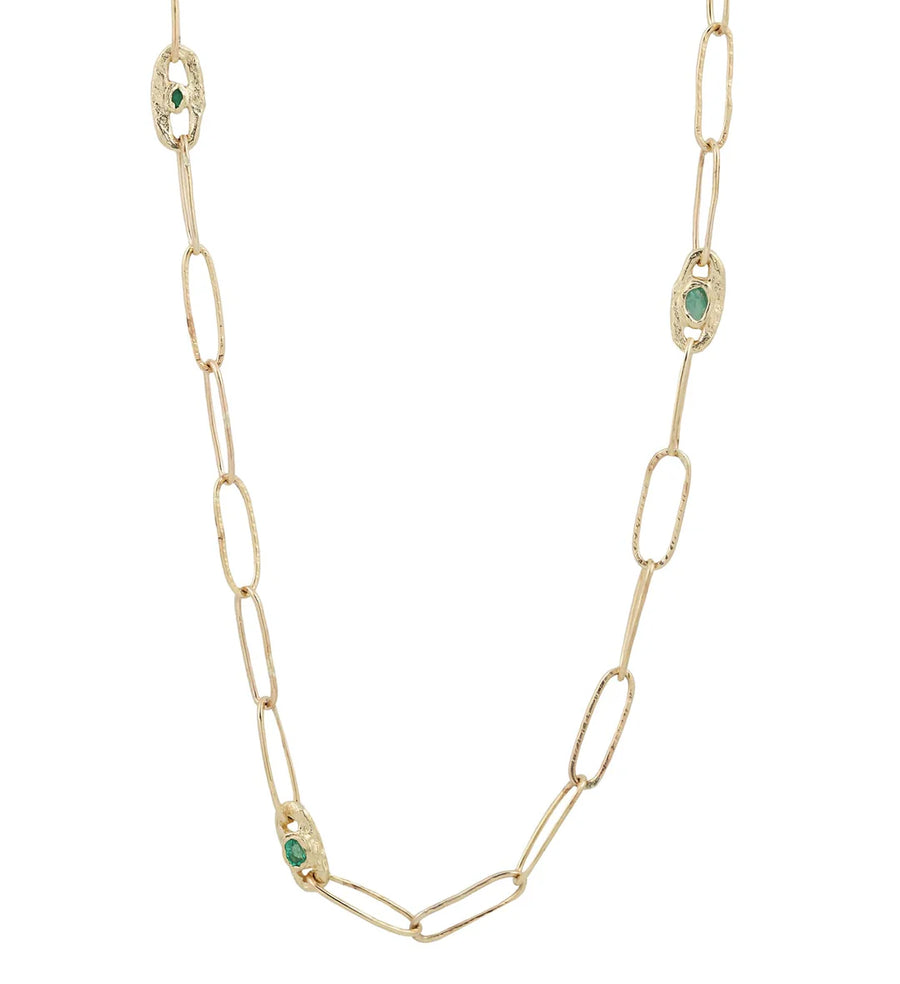 emeralds delicately placed on a hand-crafted textured chain, complemented by textured cast links. The chain consists of three links and a distinctive clasp, each adorned with a variety of emerald shades and tones.