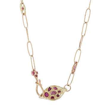 This exquisite piece features a variety of Rubies delicately placed on a hand-crafted textured chain, complemented by textured cast links