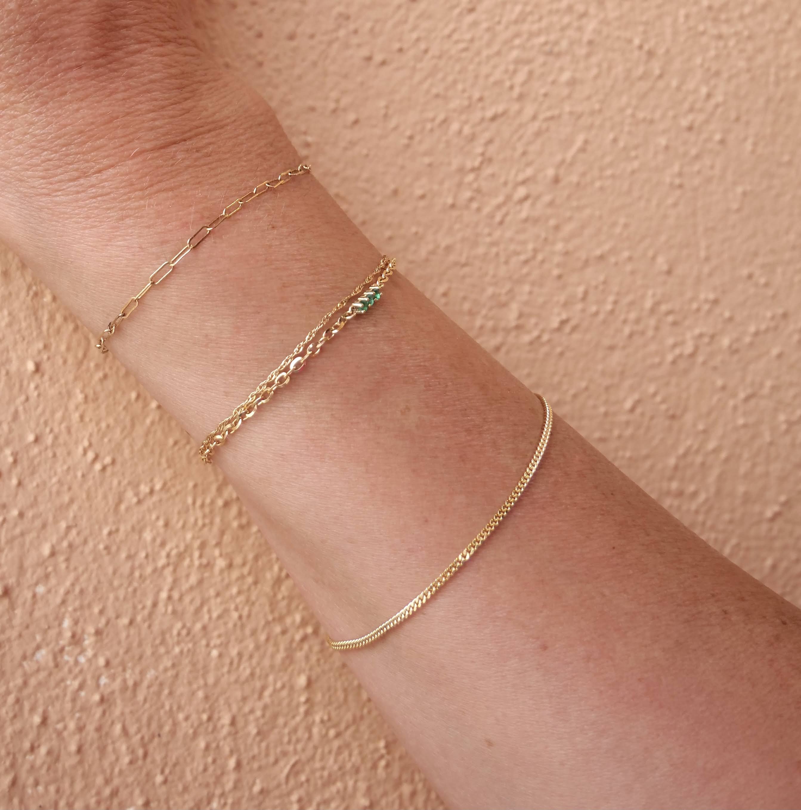 arm with three gold bracelets 