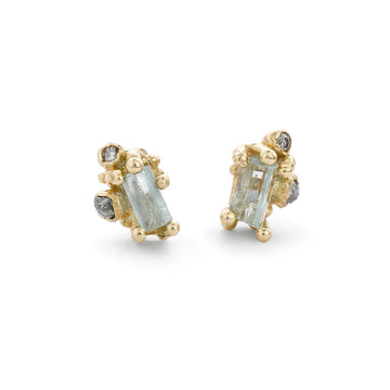 Raw aquamarine earrings punctuated with grey diamonds, on studs with a butterfly post