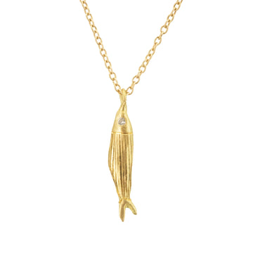 A playful hand engraved 18k gold fish shaped pendant with a diamond eye.