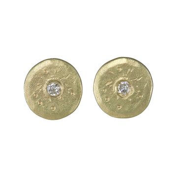 round gold disks with white diamonds set in the center