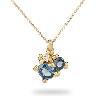 Asymmetric sapphire pendant with golden granules and single white diamond, on a fine link chain with toggle clasp