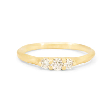 Gold ring with three diamonds on a white background
