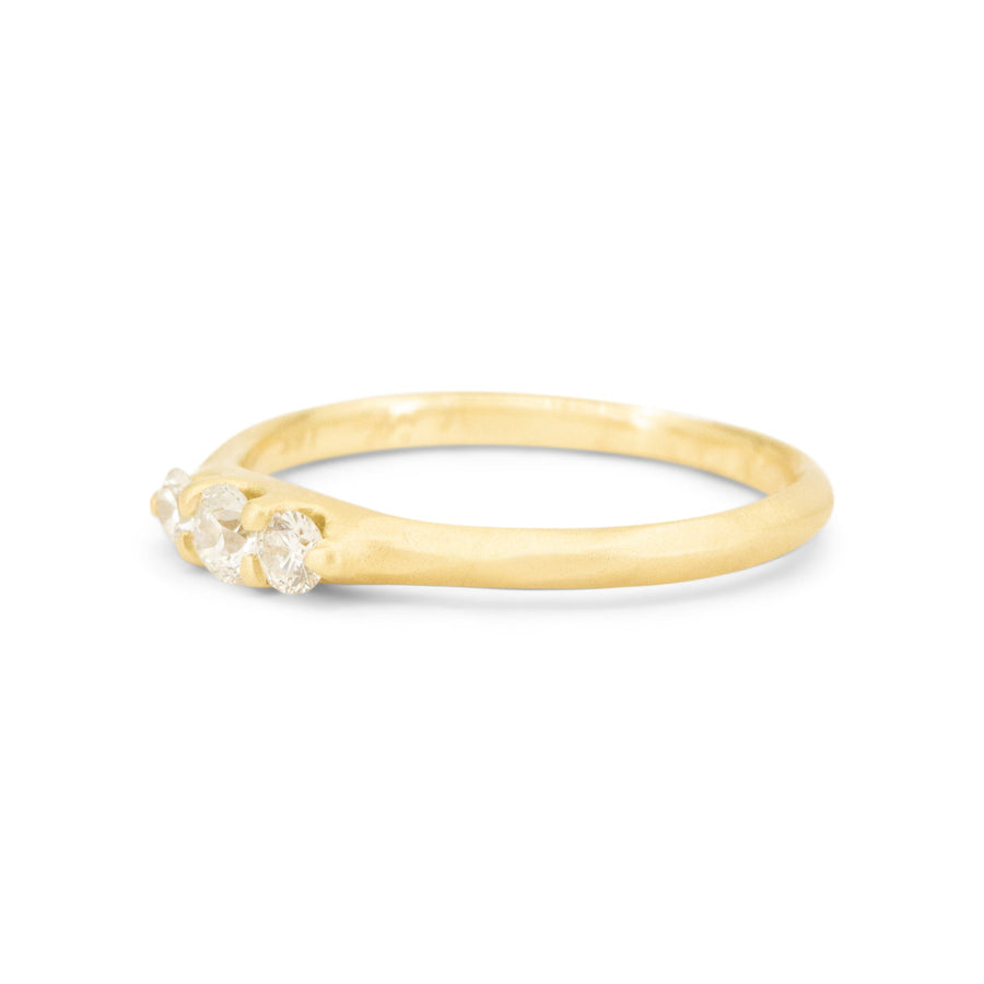 Gold ring with small diamonds on a white background