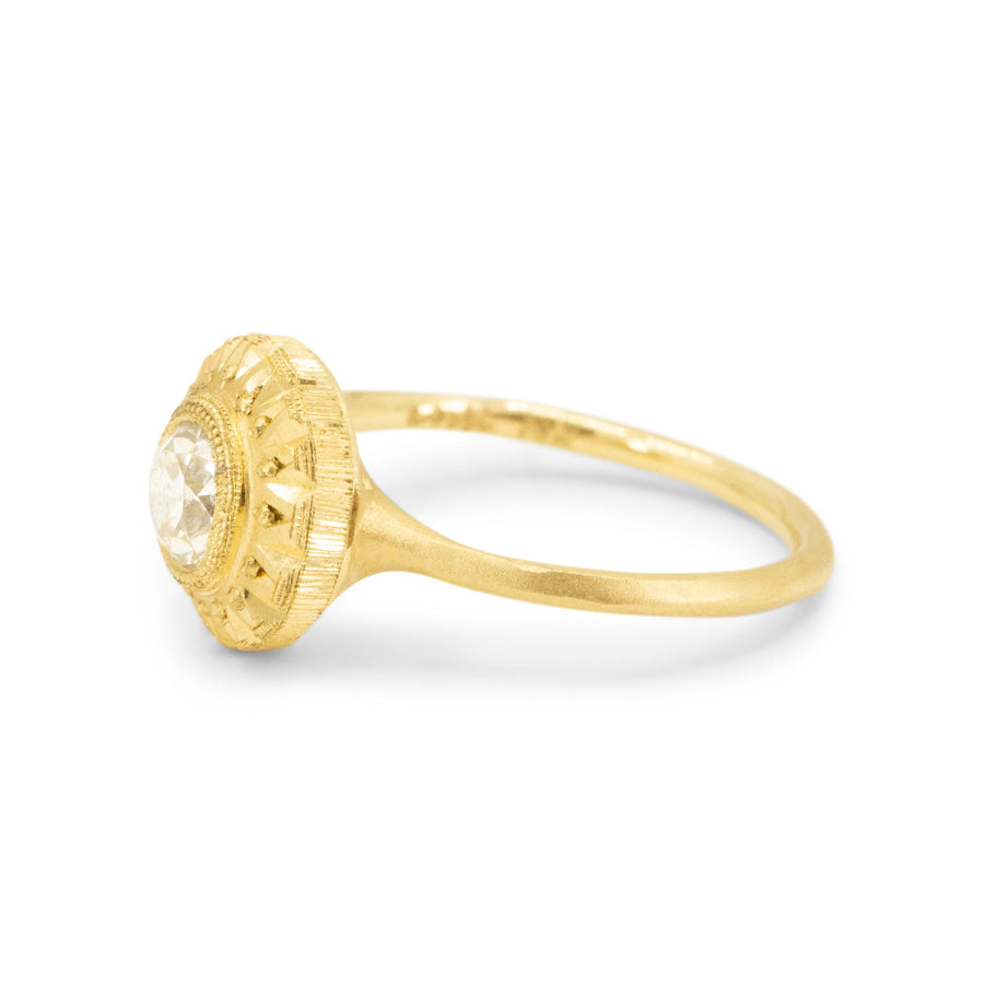 Gold ring with a diamond on a white background