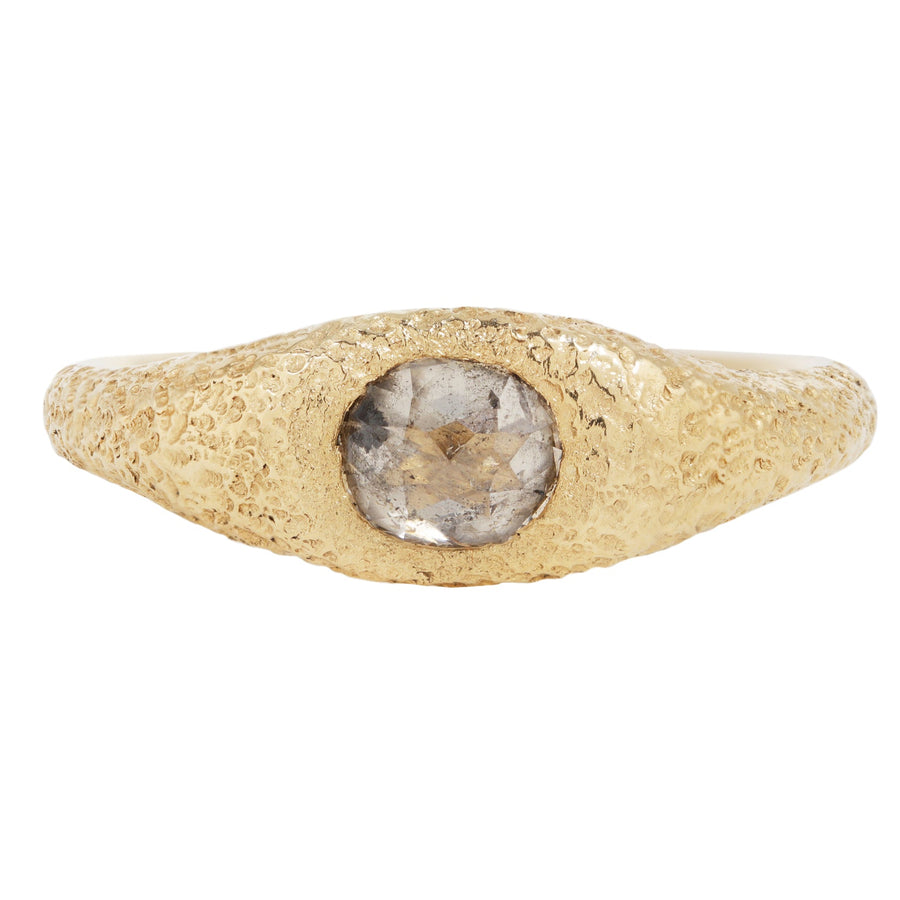Gold ring with a central stone on a white background