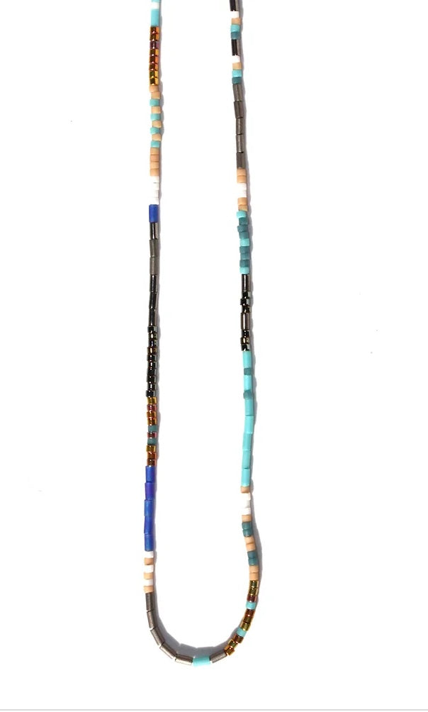Long, handmade Thin Beaded Necklace with a variety of colorful beads including blues, browns, and blacks displayed against a white background by Julie Rofman Jewelry.