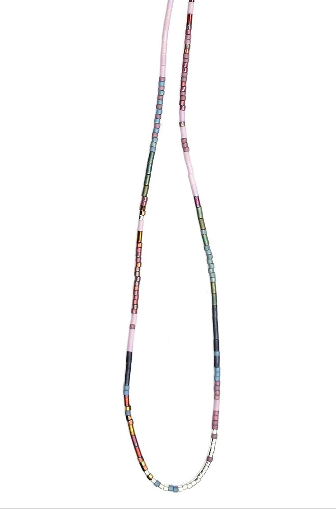 Two strands of Julie Rofman Jewelry Thin Beaded Necklaces against a white background, featuring a variety of beads in different shapes and colors, connected at the bottom with a sterling silver clasp.
