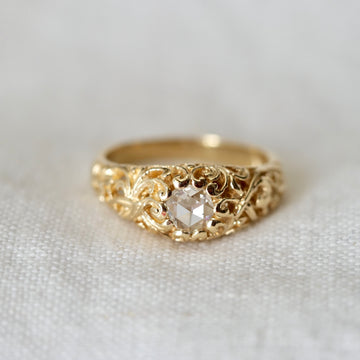 rose cut diamond ring in gold on white linen backdrop