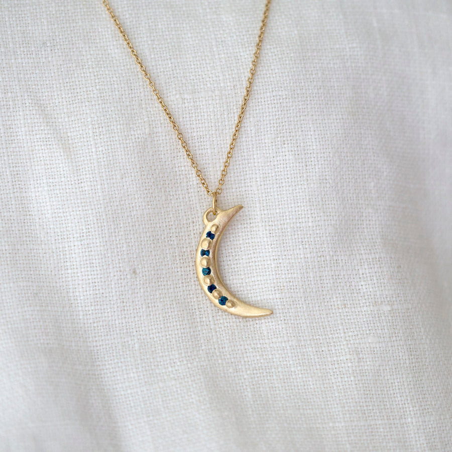 14k gold crescent moon pendant with five deep blue tourmaline bead set between gold granulation, creating a perfect pendant