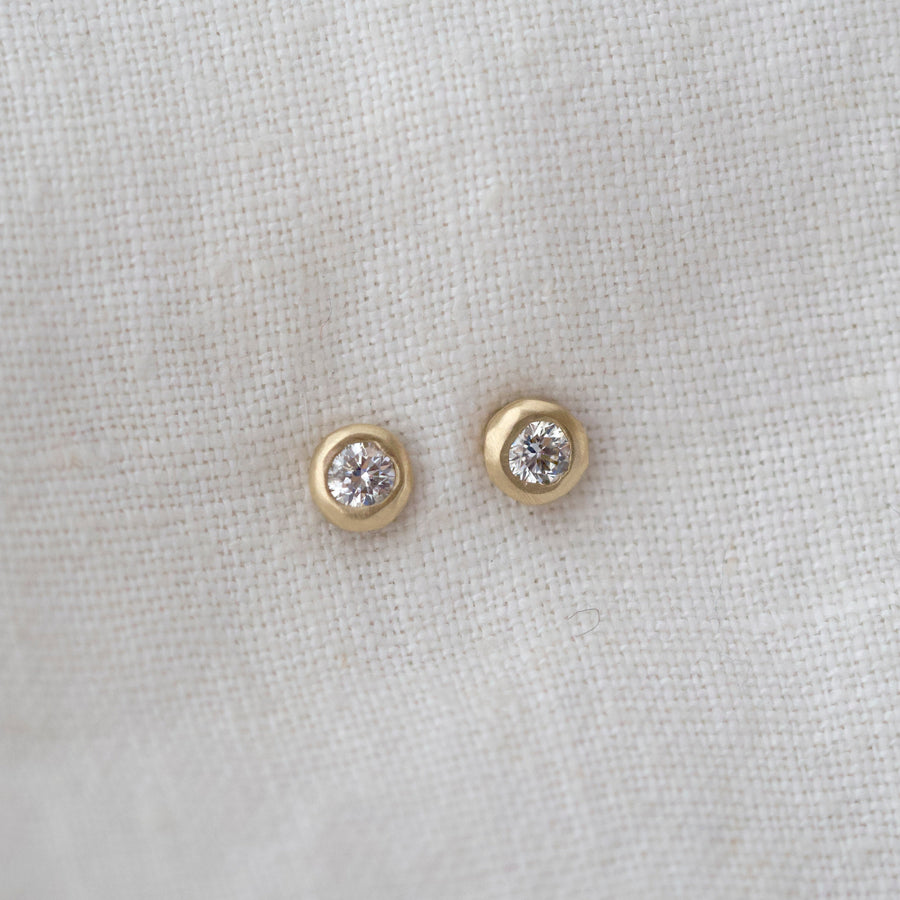 studs made of Diamonds flush set in 14k gold pebble shapes