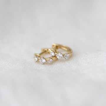 Gold ring with diamonds on a white background
