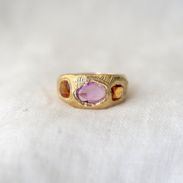 sculptural 18 karat gold hand carved band flush set with 3 vibrant freeform rose cut sapphires, two orange and one pink