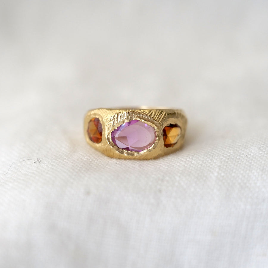 sculptural 18 karat gold hand carved band flush set with 3 vibrant freeform rose cut sapphires, two orange and one pink