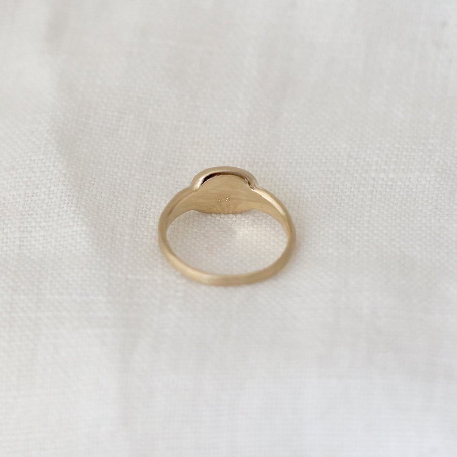 Gold ring on a white fabric background