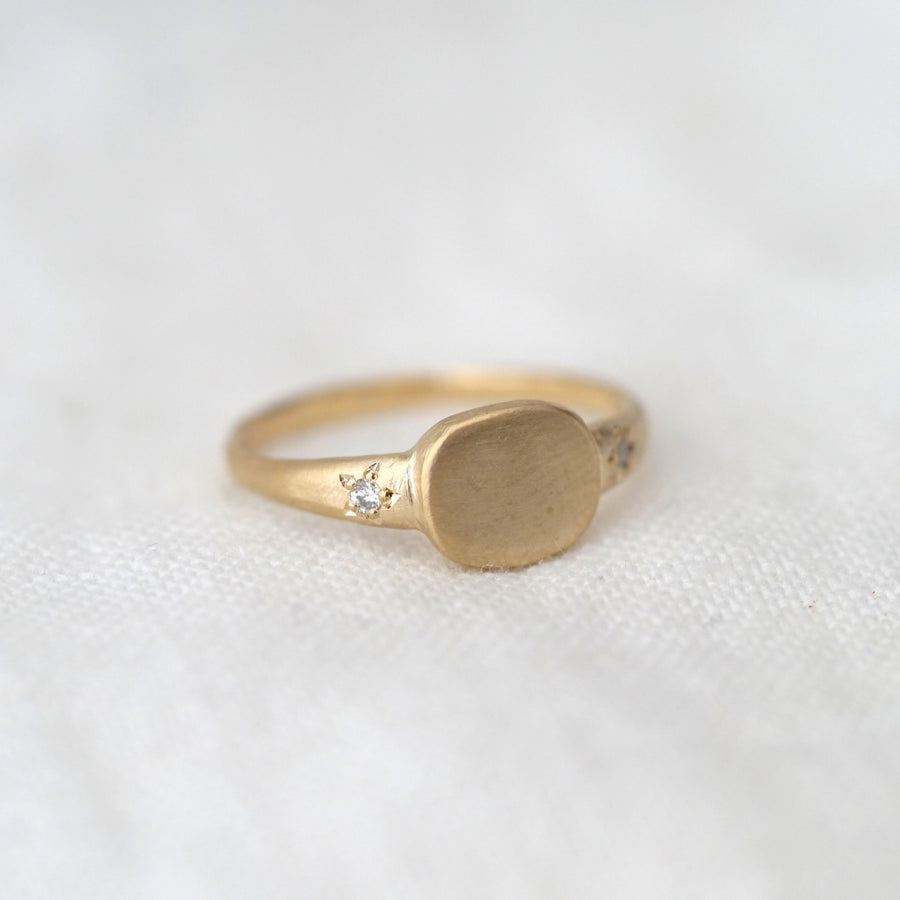 Gold ring with a circular design on a white background