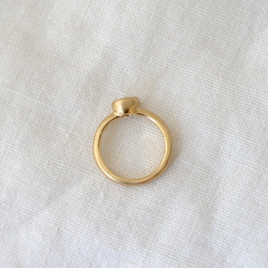 Gold ring on a light fabric background
