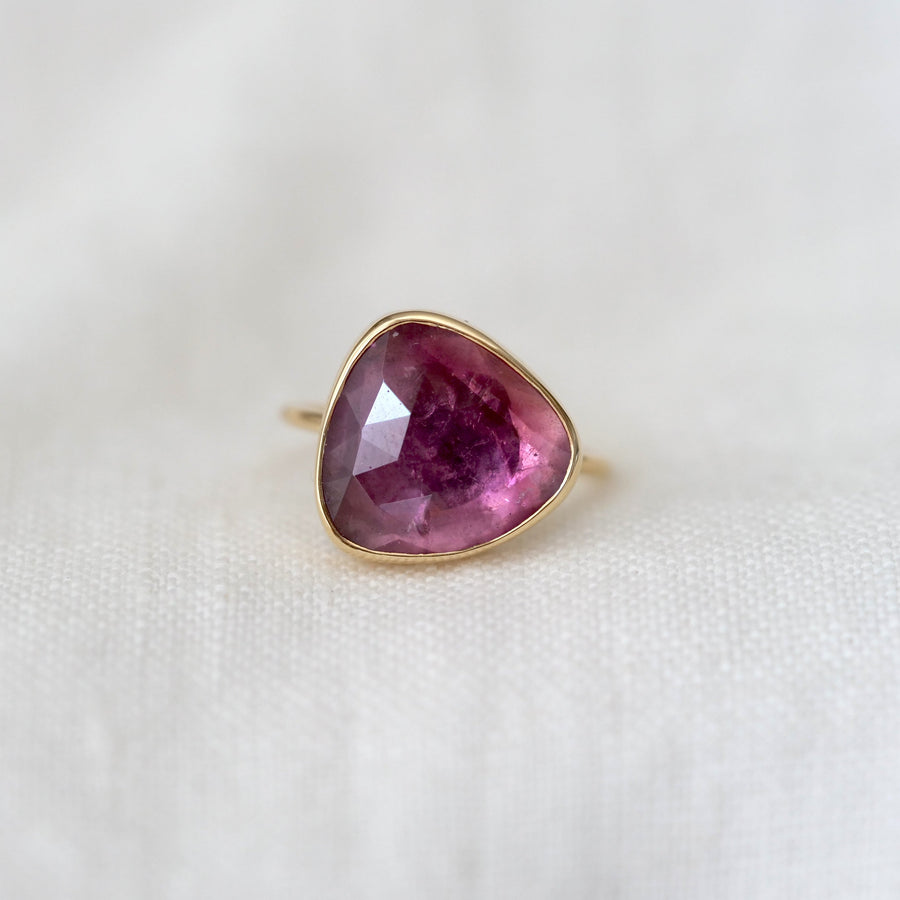 Ring with a pink gemstone on a white background