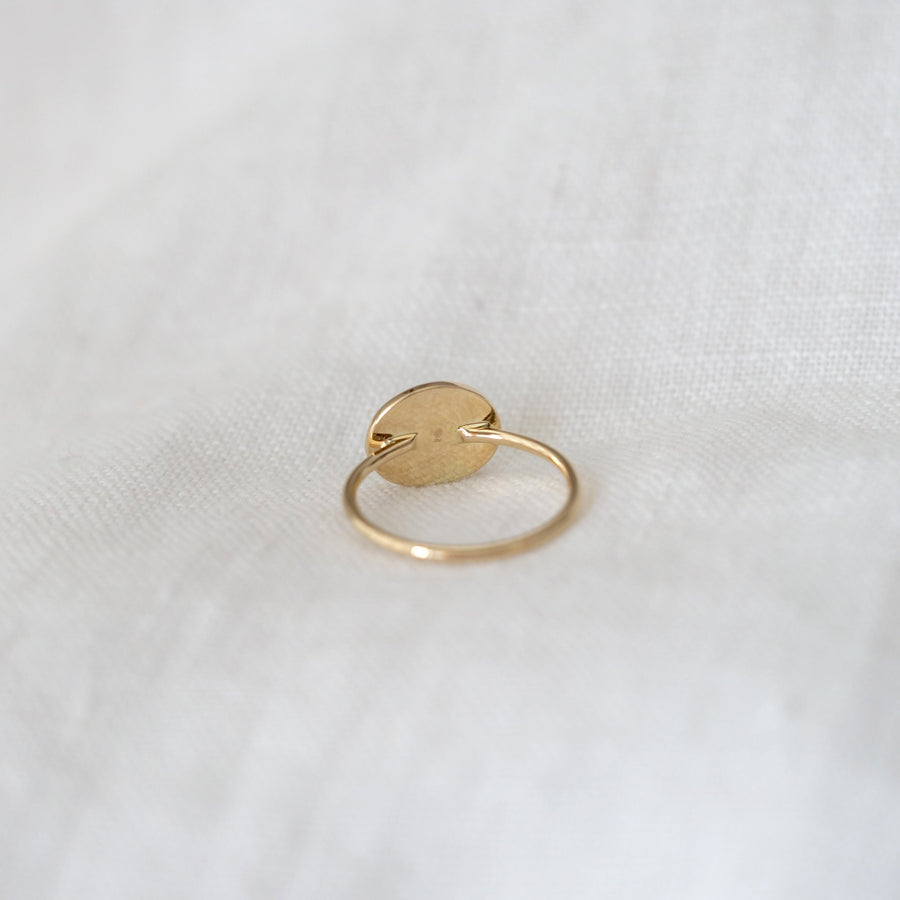 Gold ring on a white fabric background