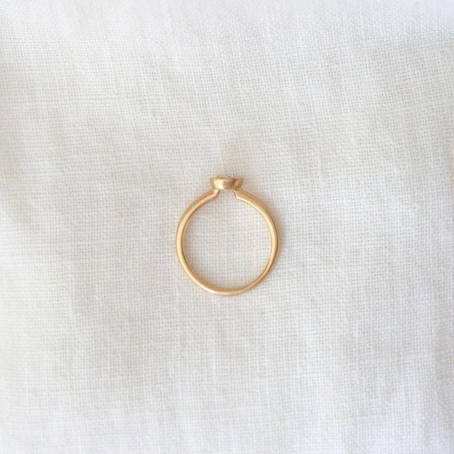 Gold ring on a white fabric background